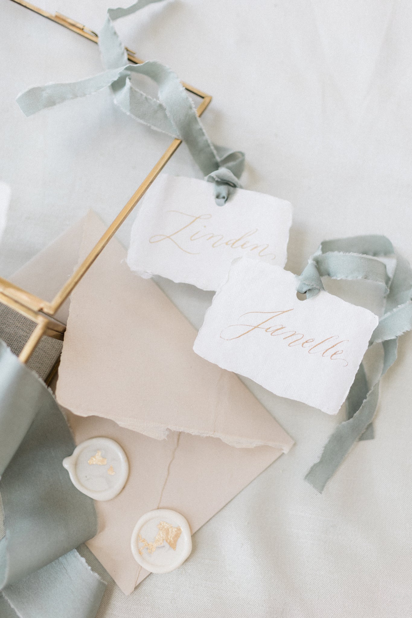 Calligraphy place cards by Papelu Studio – this intimate Canmore, Alberta wedding has a classic palette pairing of blush and sage. Credits: Photo by Modern Nest Photography, Wedding Design & Styling by Rebekah Bronte Design and Bronte Bride